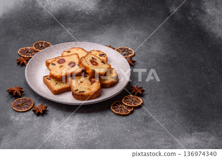 Fruit cake, a dessert with cherries, plums, and raisins for a festive Christmas table. Fruit cake Fruit cake, a dessert with cherries, plums, and raisins for a festive Christmas table. Fruit cake 136974340