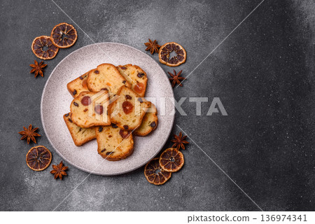 Fruit cake, a dessert with cherries, plums, and raisins for a festive Christmas table. Fruit cake Fruit cake, a dessert with cherries, plums, and raisins for a festive Christmas table. Fruit cake 136974341