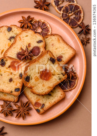 Fruit cake, a dessert with cherries, plums, and raisins for a festive Christmas table. Fruit cake Fruit cake, a dessert with cherries, plums, and raisins for a festive Christmas table. Fruit cake 136974365