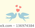 two birds are flying with hearts in their beaks 136974384