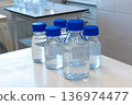 Laboratory glass bottles with samples in incubator for microbiological testing 136974477