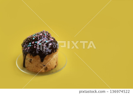 Easter cake with chocolate glaze on light yellow background, clean minimal composition with copy space for text 136974522