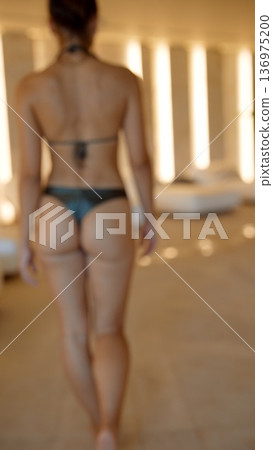 Silent spa walk. Calm woman moves quietly along peaceful spa hallway 136975200