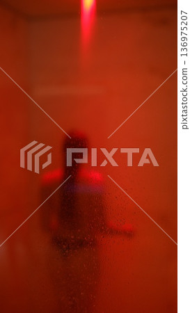Intimate setting featuring blurred figure and misted glass Intimate setting featuring blurred figure and misted glass 136975207