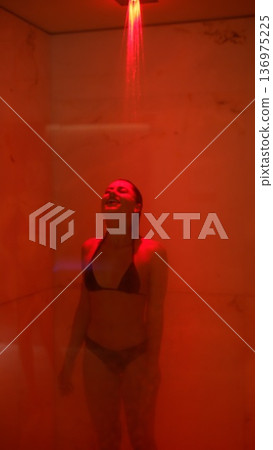 Female athlete performing post workout stretches in wellness setting 136975225