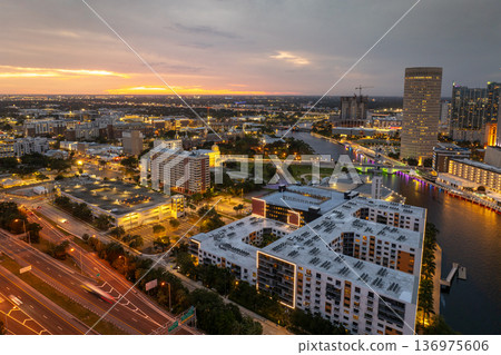 Downtown of Tampa in Florida, USA. Car traffic on city streets and brightly illuminated high skyscraper buildings. American travel destination. Downtown of Tampa in Florida, USA. Car traffic on city streets and brightly illuminated high skyscraper buildings. American travel destination. 136975606