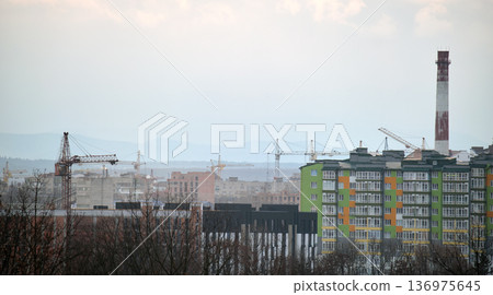 Tower cranes at high residential apartment buildings construction site. Real estate development 136975645