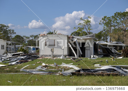 Badly damaged mobile homes after hurricane in Florida residential area. Consequences of natural disaster 136975668