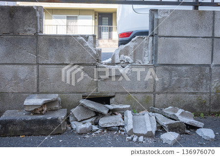Destroyed concrete block wall 136976070