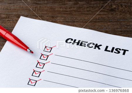Checklist paper with checks made with red pen Checklist paper with checks made with red pen 136976868