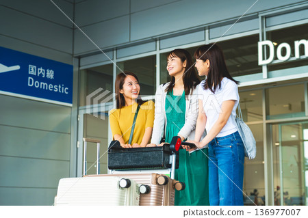 Three women chatting at the airport. Photo courtesy of Kansai International Airport (KIX). 136977007