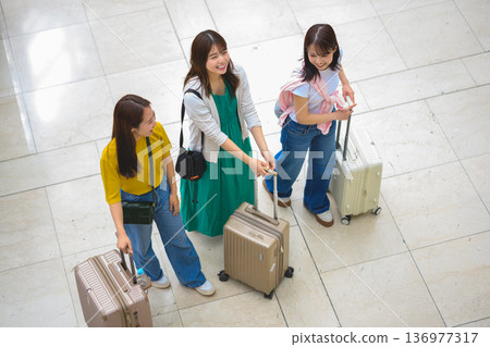 A woman pulling a suitcase at the airport. Photo courtesy of Kansai International Airport (KIX) A woman pulling a suitcase at the airport. Photo courtesy of Kansai International Airport (KIX) 136977317
