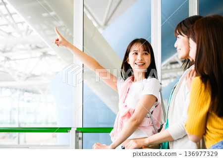 A woman giving directions to a friend at the airport. Photo courtesy of Kansai International Airport (KIX) A woman giving directions to a friend at the airport. Photo courtesy of Kansai International Airport (KIX) 136977329