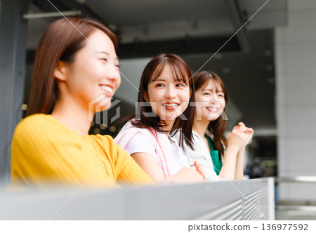 Three women chatting at the airport. Photo courtesy of Kansai International Airport (KIX). Three women chatting at the airport. Photo courtesy of Kansai International Airport (KIX). 136977592