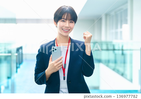 Businesswomen looking at Suho in the office. Photo courtesy of Sky Perfect Tokyo Media Center. 136977782