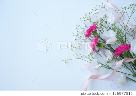 A gift and red carnations to express gratitude on an anniversary A gift and red carnations to express gratitude on an anniversary 136977815