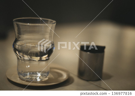 A quiet scene on a coffee shop table with a glass of cold water 136977816