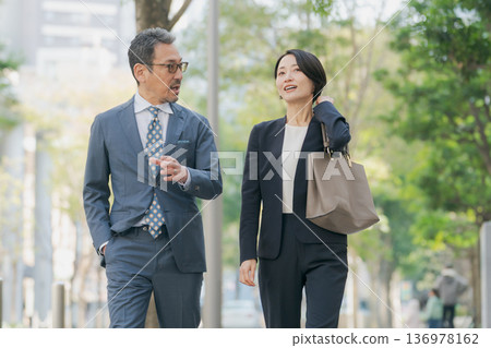 Two business people discussing 136978162