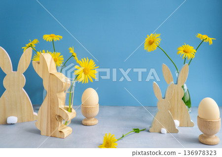 Copy space mock up postcard greeting card with bunny wooden figures and fresh flowers. Easter composition content still life. Christian symbols of spring Copy space mock up postcard greeting card with bunny wooden figures and fresh flowers. Easter composition content still life. Christian symbols of spring 136978323