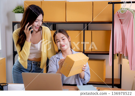 Two asian woman e-commerce startup in home office, two young entrepreneur management order. Two asian woman e-commerce startup in home office, two young entrepreneur management order. 136978522