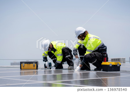 Solar panel installer engineer team installing photovoltaic system renewable energy power rooftop. Solar panel installer engineer team installing photovoltaic system renewable energy power rooftop. 136978540