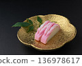 Red and white kamaboko on a plate 136978617