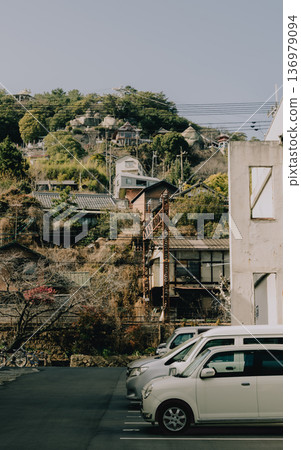 Onomichi's hidden beauty: A glimpse of the ocean beyond the buildings and a landscape with depth created by the slopes Onomichi's hidden beauty: A glimpse of the ocean beyond the buildings and a landscape with depth created by the slopes 136979094