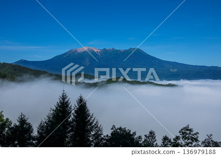 Mount Ontake floating in a sea of clouds from Kaida Plateau, Kiso Town, Nagano Prefecture Mount Ontake floating in a sea of clouds from Kaida Plateau, Kiso Town, Nagano Prefecture 136979188