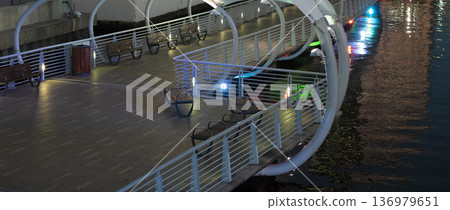 Pedestrian riverwalk trail alongside river water in downtown district of Tampa city in Florida, USA. Recreational area in modern american megapolis Pedestrian riverwalk trail alongside river water in downtown district of Tampa city in Florida, USA. Recreational area in modern american megapolis 136979651