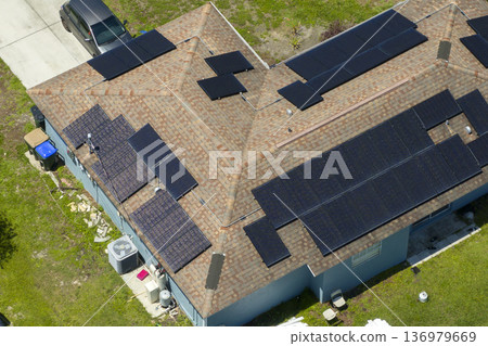 Autonomous home. Solar panels on house roof. Photovoltaic sells for producing clean ecological electric energy. Investing in renewable electricity for retirement income 136979669