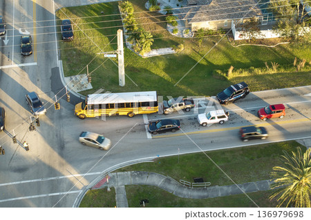 Damaged truck and school bus in traffic accident on American road 136979698