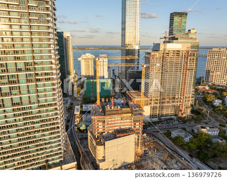 Miami, Florida. Developing American megapolis with new high-rise buildings under construction at sunset Miami, Florida. Developing American megapolis with new high-rise buildings under construction at sunset 136979726