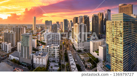 Aerial view of downtown office district of Miami Brickell in Florida, USA. High commercial and residential skyscraper buildings in modern American megapolis at sunset Aerial view of downtown office district of Miami Brickell in Florida, USA. High commercial and residential skyscraper buildings in modern American megapolis at sunset 136979727