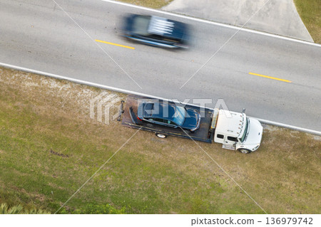 Car accident on city street in Florida. Emergency services and tow truck at vehicle crash in USA 136979742