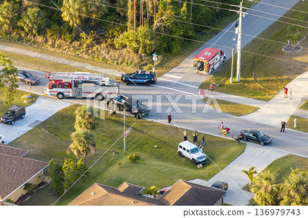First responders responding to car accident site on American street. Emergency services helping victims of vehicle crash on road in USA First responders responding to car accident site on American street. Emergency services helping victims of vehicle crash on road in USA 136979743
