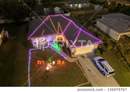 Festive yard display with glowing lights and Christmas decorations at a Florida family home. New Year holiday joy. Festive yard display with glowing lights and Christmas decorations at a Florida family home. New Year holiday joy. 136979767