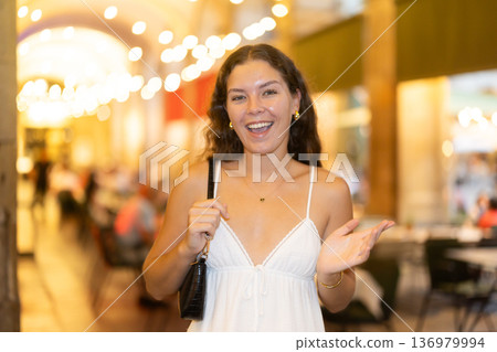 In night, young smiling girl walks along city street Ferran 136979994