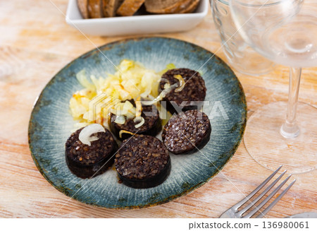 Slices of fried morcilla served with caramelized onions Slices of fried morcilla served with caramelized onions 136980061