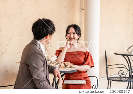 Couple in colored dresses sitting on chairs, married couple, bride and groom, dressed up couple, wealthy, wealthy Couple in colored dresses sitting on chairs, married couple, bride and groom, dressed up couple, wealthy, wealthy 136980167