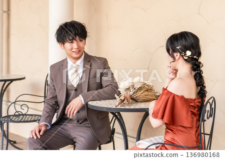 Couple in colored dresses sitting on chairs, married couple, bride and groom, dressed up couple, wealthy, wealthy Couple in colored dresses sitting on chairs, married couple, bride and groom, dressed up couple, wealthy, wealthy 136980168
