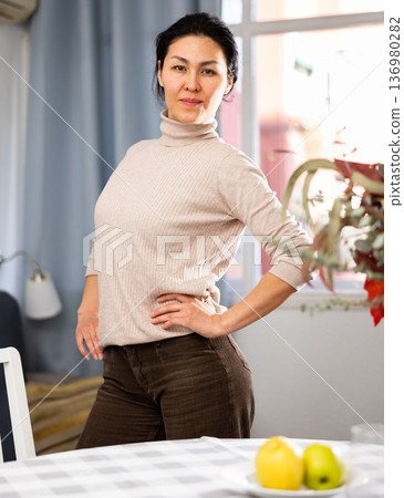 Portrait of a positive asian woman posing for the camera Portrait of a positive asian woman posing for the camera 136980282