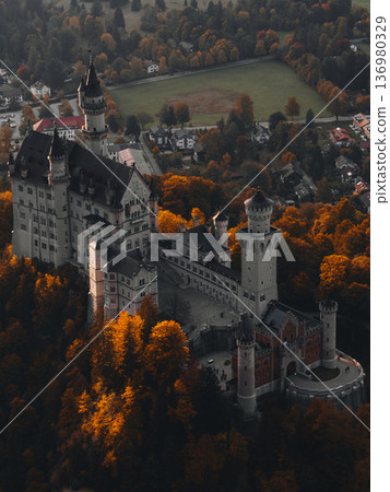 Historic castle surrounded by vibrant autumn foliage in a scenic landscape 136980329