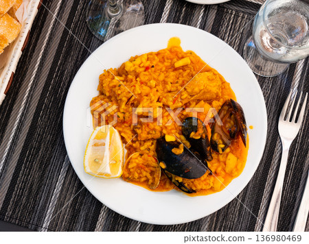 chicken and seafood paella 136980469