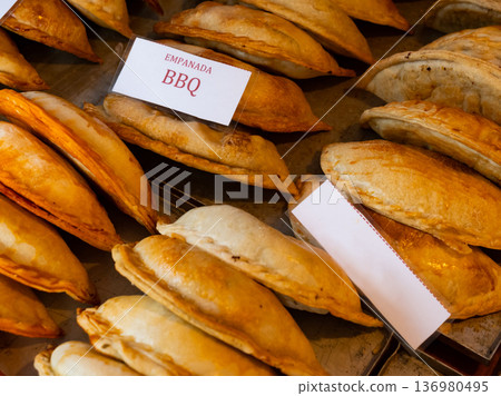 Rows of fresh, just baked empanadas Rows of fresh, just baked empanadas 136980495