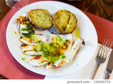 Grilled cuttlefish served with garlic and parsley Grilled cuttlefish served with garlic and parsley 136980759