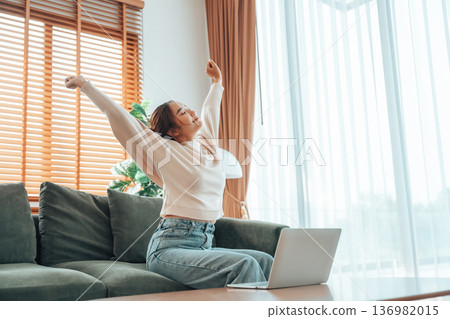 Young asian woman feeling pain in neck and shoulder after working on computer laptop for a long time Young asian woman feeling pain in neck and shoulder after working on computer laptop for a long time 136982015