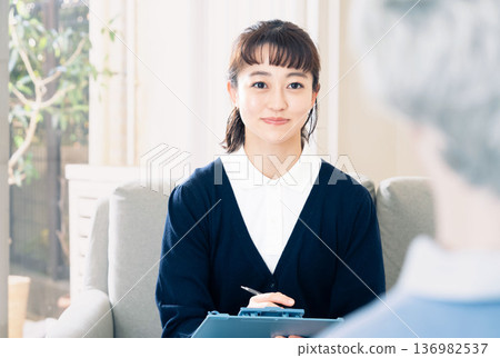 A female care manager talking to a client A female care manager talking to a client 136982537