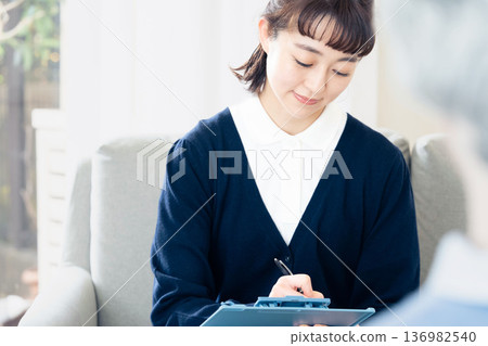 A female care manager talking to a client A female care manager talking to a client 136982540
