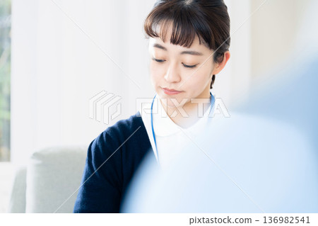 A female care manager talking to a client A female care manager talking to a client 136982541