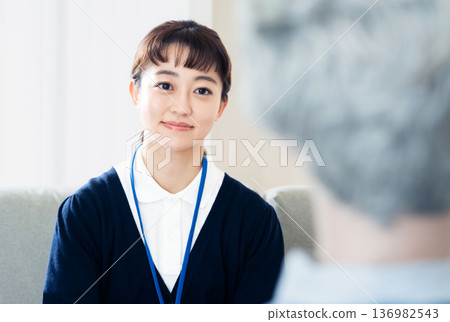 A female care manager talking to a client A female care manager talking to a client 136982543